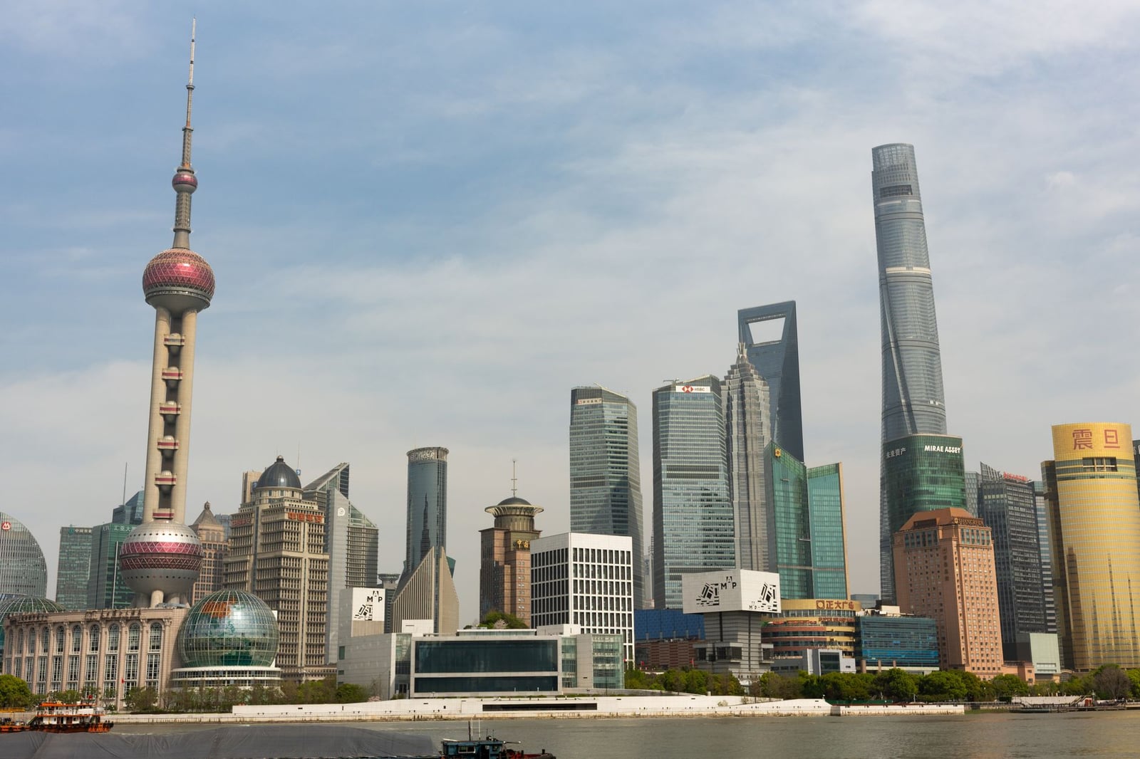 Vista panorámica del horizonte de Shanghái, con la Torre Perla Oriental bajo un cielo azul despejado.