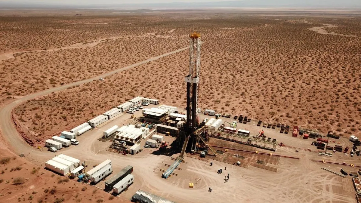 oil pipeline infrastructure in Patagonia Argentina, Vaca Muerta oil field, aerial view of drilling rigs and storage tanks, arid landscape, no people